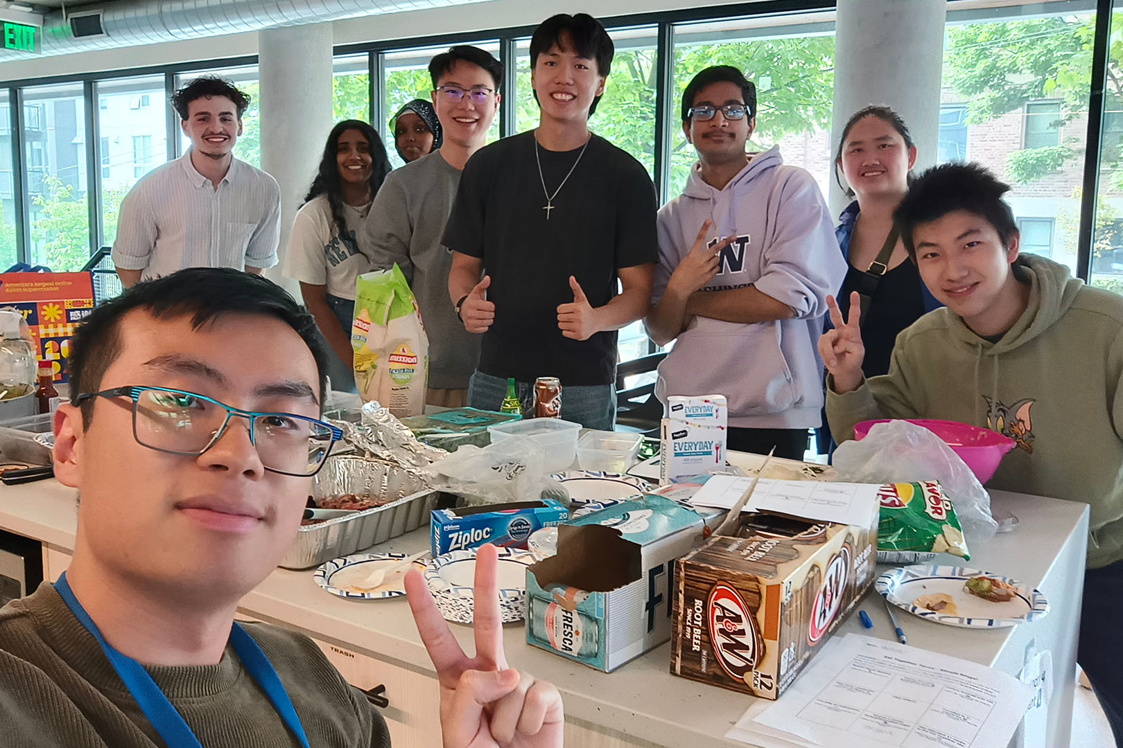 a diverse group of students around a table set up for a meal