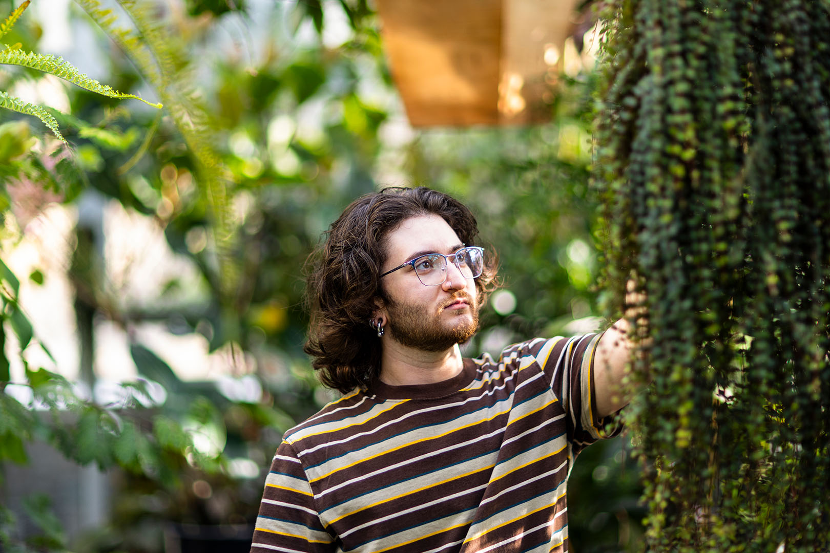 gabriel landau reaching and touching a plant